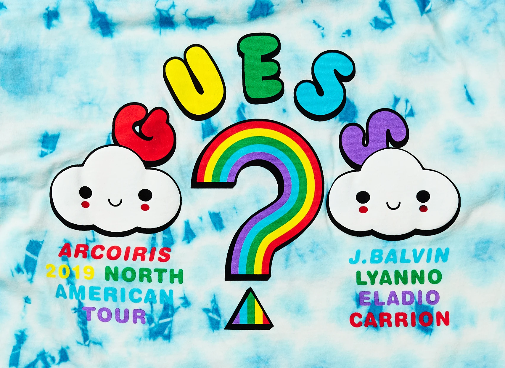 Colorful Arcoíris 2019 Tour graphic combining J Balvin, GUESS, and FriendsWithYou typography with smiling cloud characters.