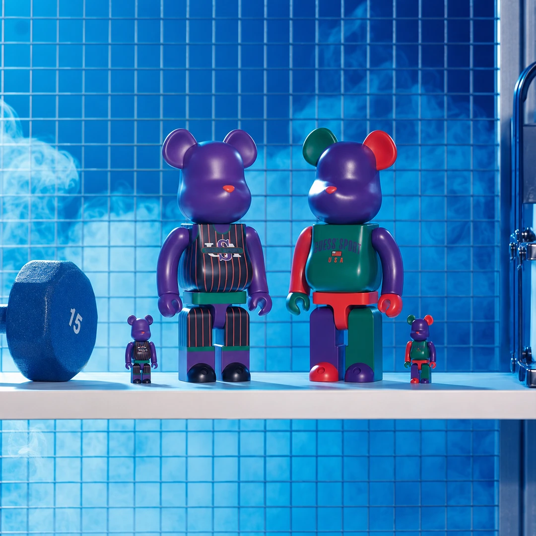 Guess Sport Bearbrick figures photographed in a blue gym-inspired setting.