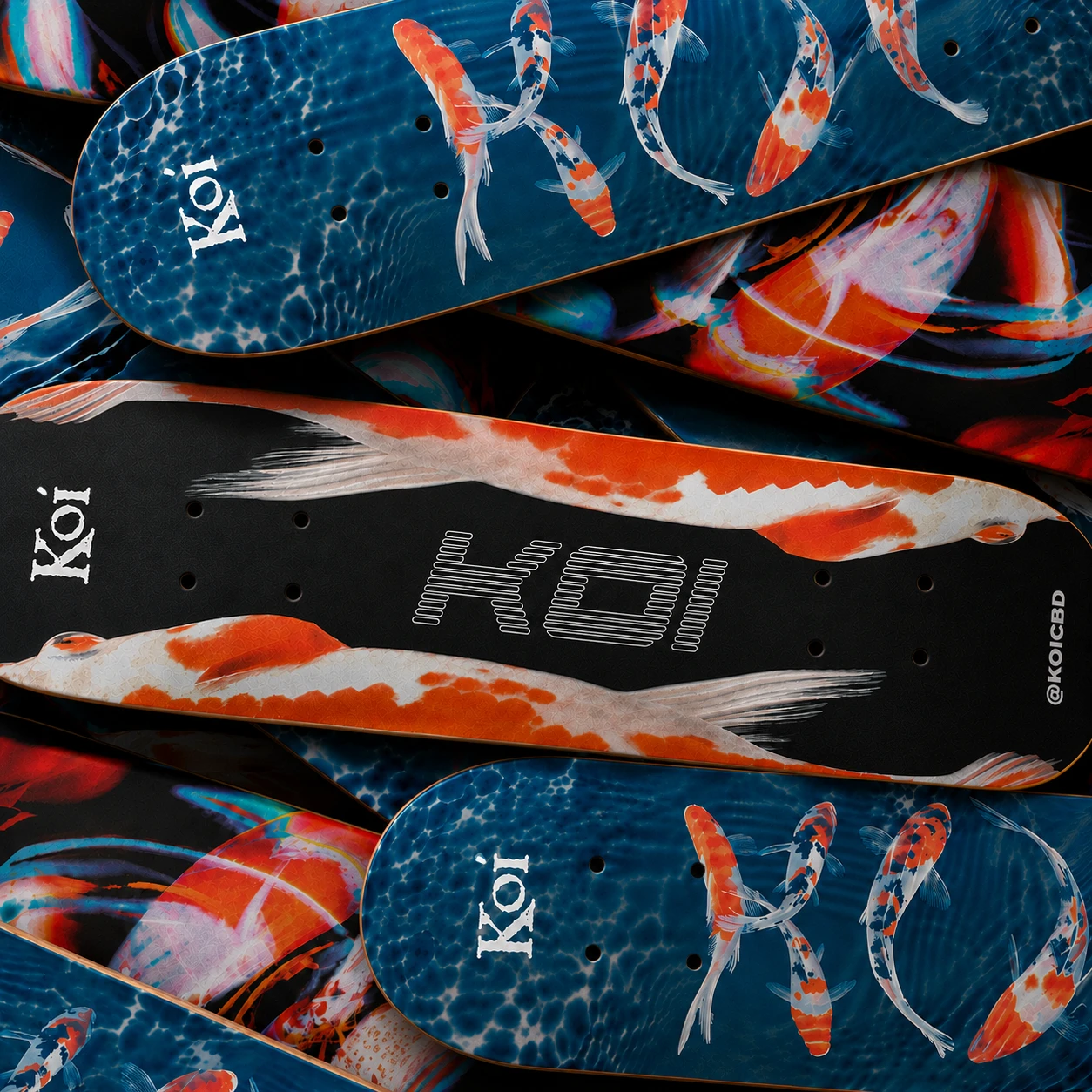 Overlapping Koi skateboard decks featuring blue, orange, and black fish artwork.