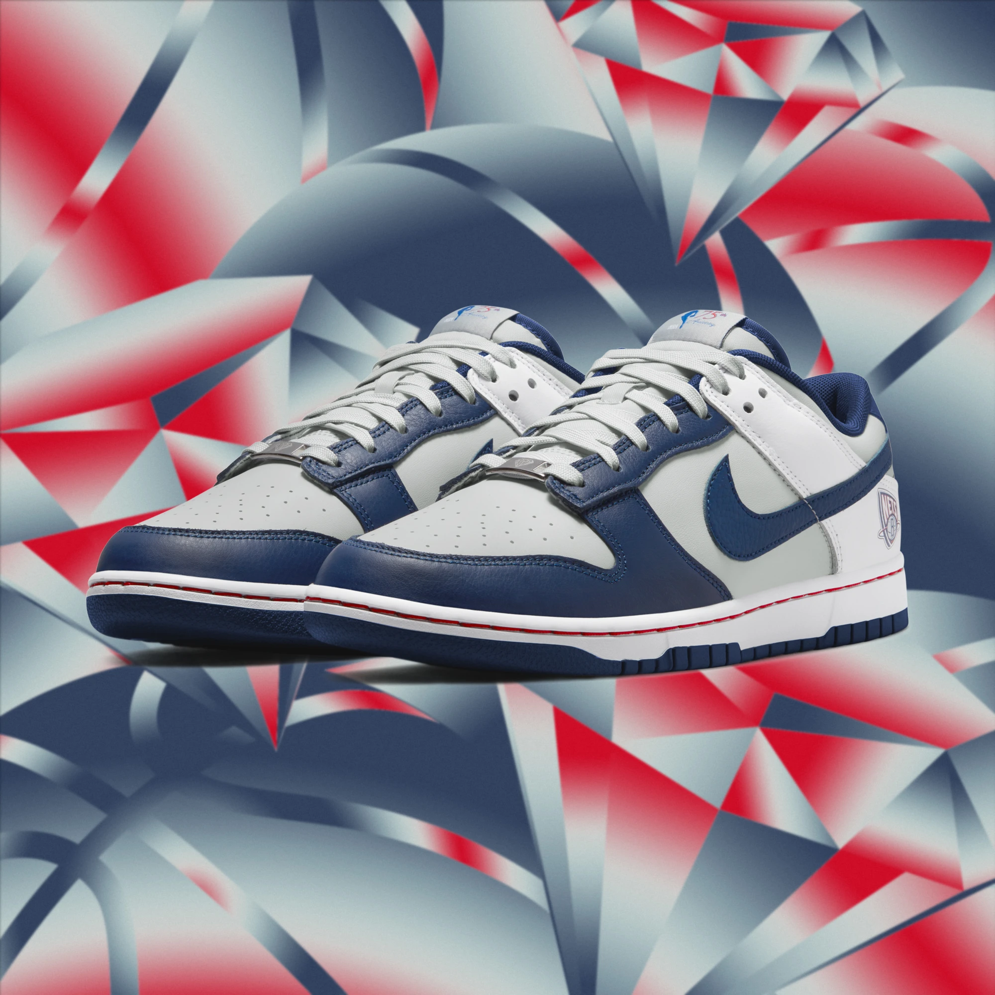 Blue-and-white Nike Dunks over an abstract red, white, and blue background.